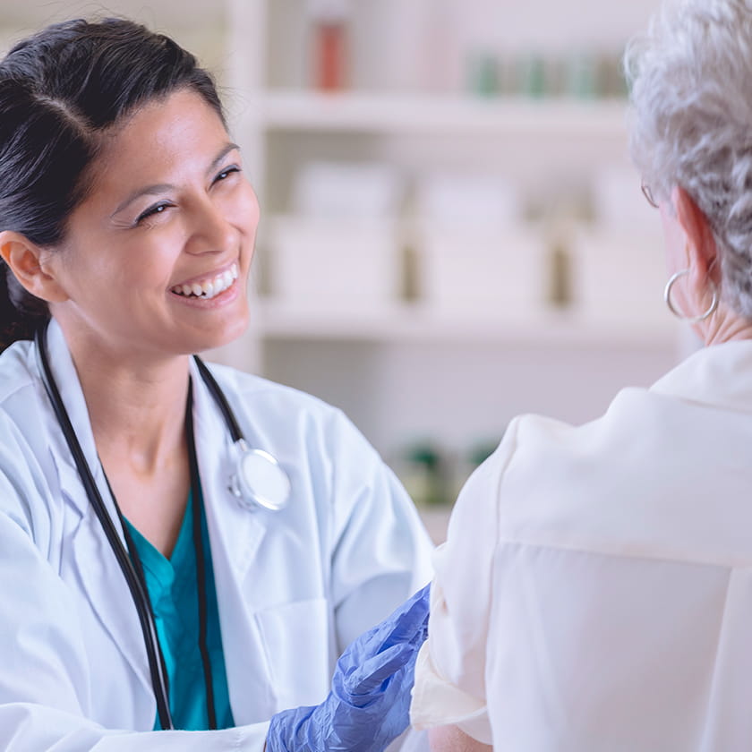 Smiling doctor performing a checkup on a patient
