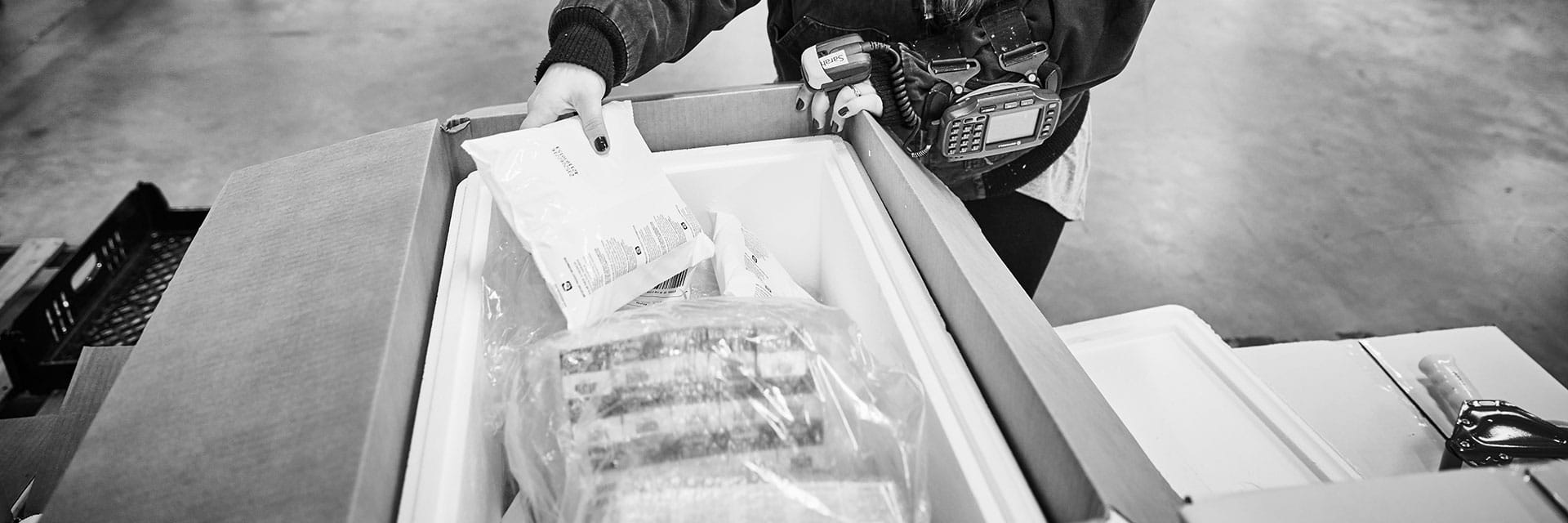 Warehouse worker scanning items and placing them in a cooler